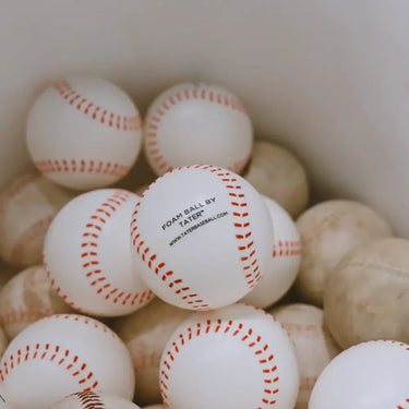 White foam baseballs with red stitching, labeled 'Foam Ball by Tater' for training and practice.