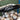 Tater brand baseball bat with logo, resting over a basket of baseballs in a training net