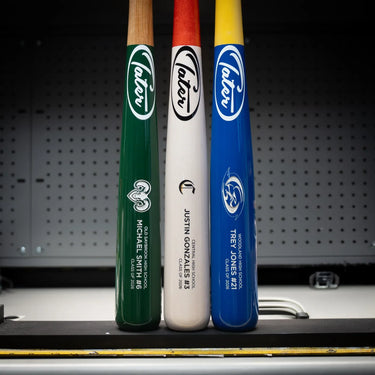 Customized Tater Baseball bats in green, white, and blue with player names and schools