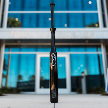 Tater Baseball G Force 2.0 Pro Maple training bat standing upright outdoors, ideal for players of all ages.