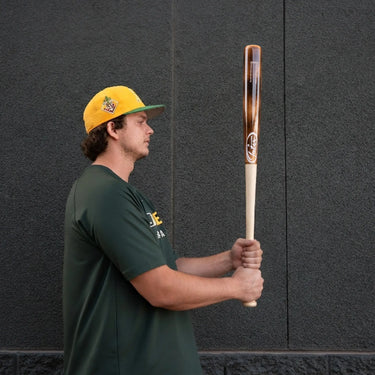 Player holding a Tater Kurtz16 Pro maple wood bat