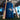 Toronto Blue Jays branded wood bats leaning on team logo bucket in indoor training facility
