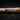 Tater wood baseball bat with branded logo on dark turf background